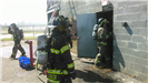 Firefighters in Gear Entering and Exiting a Building