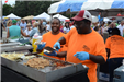 Two Men Cooking and Preparing Food on a Grill