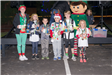 Kids Holding Trophies in Christmas Outfits