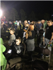 Costumed Howl-O-Scream participants waiting in lines at night