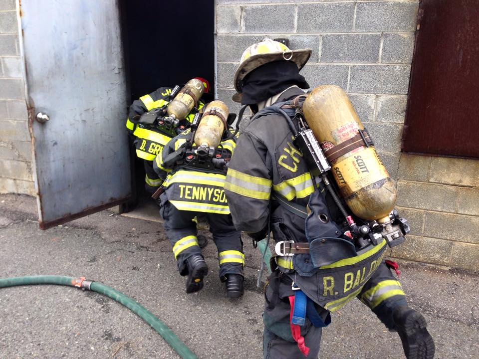 Firefighters Crouching Entering a Building During Training
